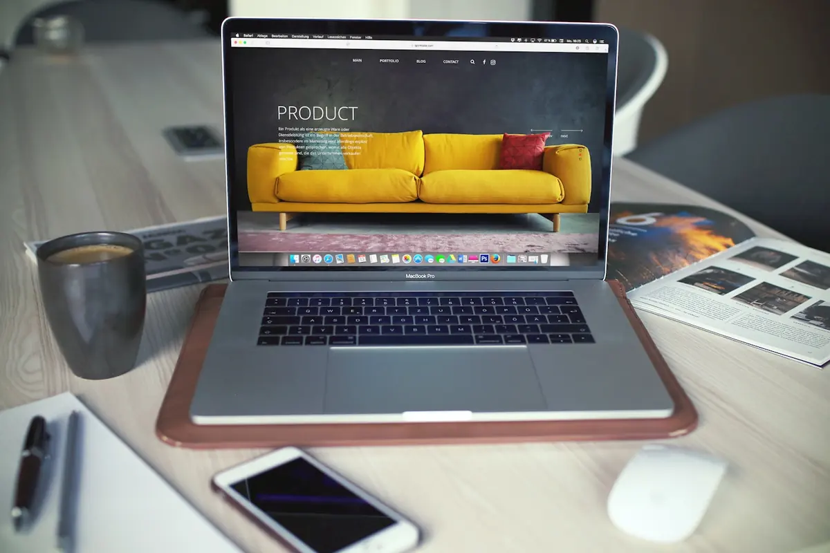 A website open on a laptop on a work desk